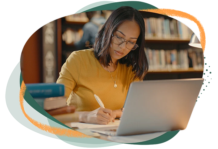 Woman studying in the library on her computer